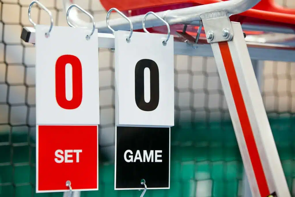 Umpire chair with scoreboard on a tennis court before the game.