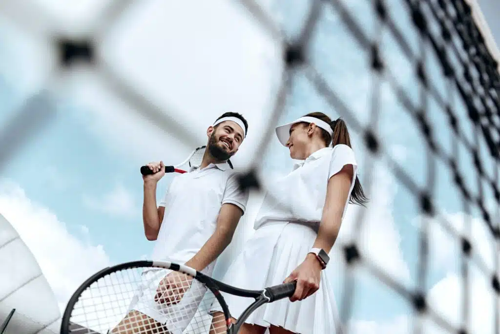 Active weekend together. Lovers play tennis