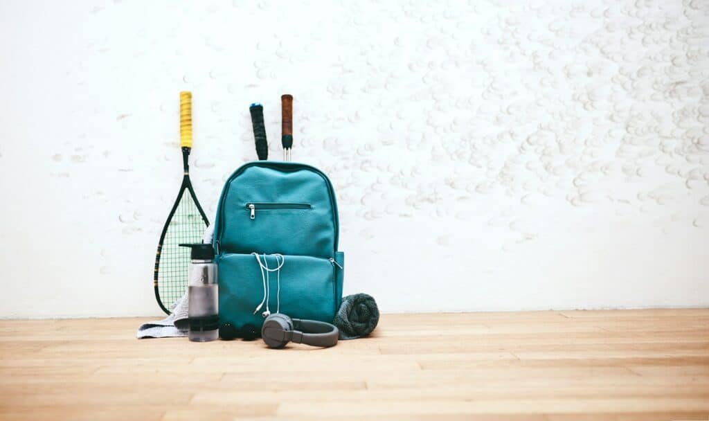 Gear fit for a pro. Shot of a sports bag and other items in an empty squash court.