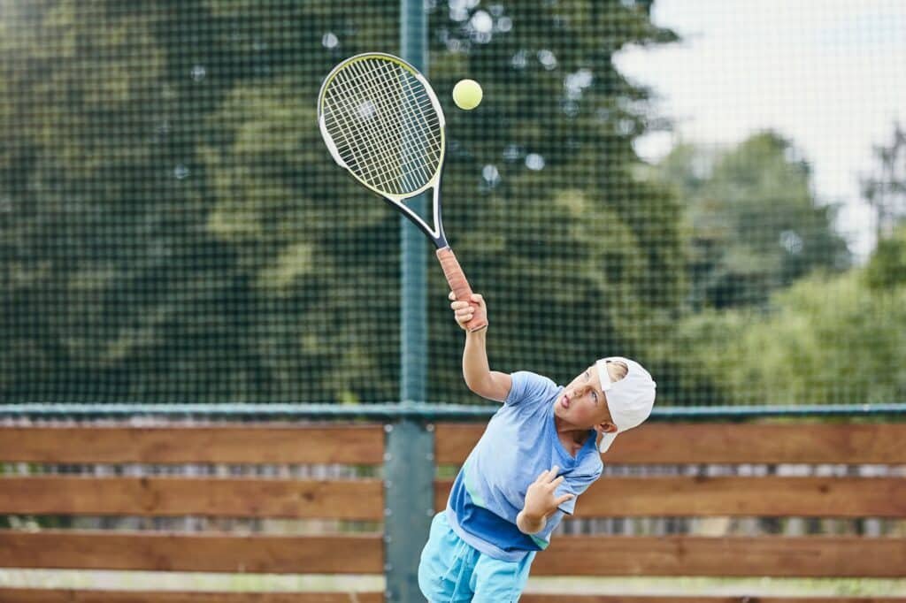 Little boy playing tennis