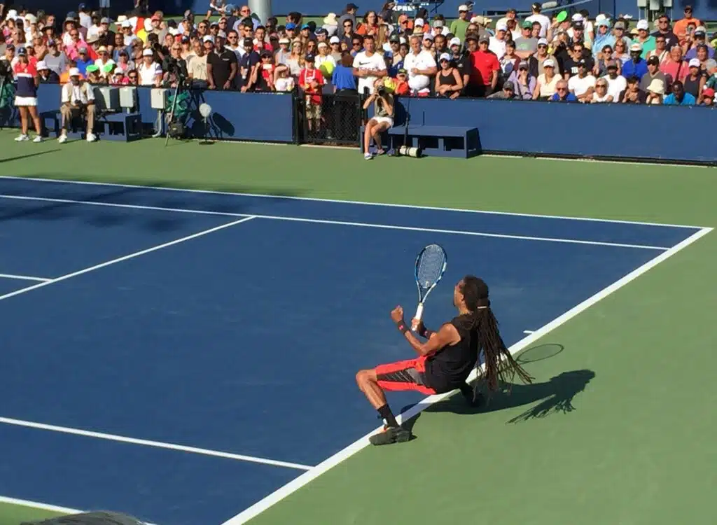 Male tennis player celebrating the winning match point at the US Open tennis tournament.