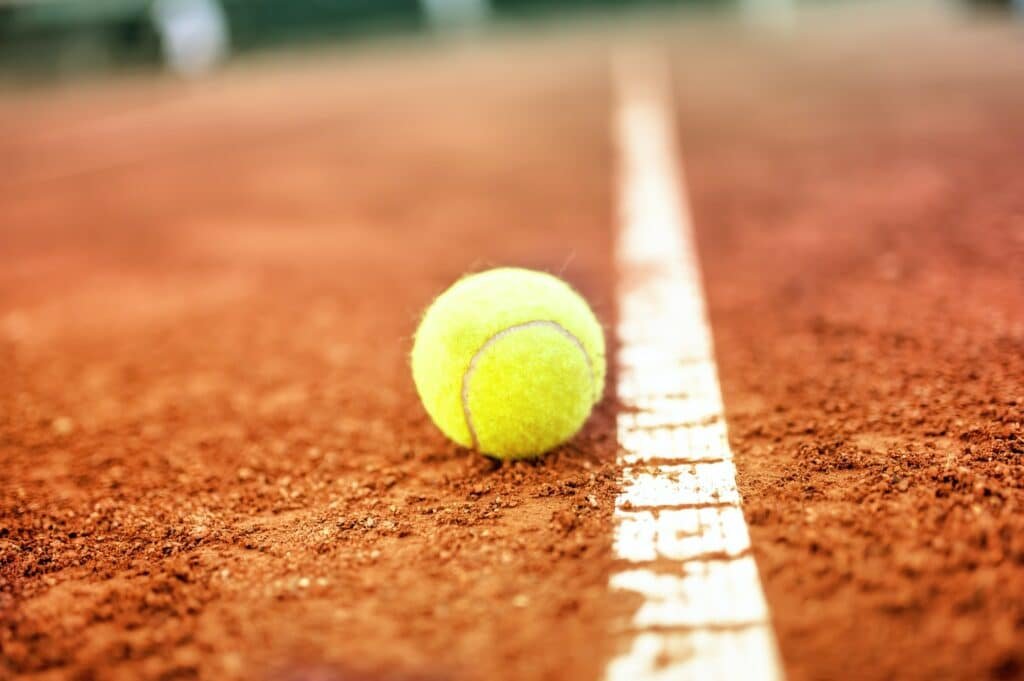 Tennis ball on a tennis clay court