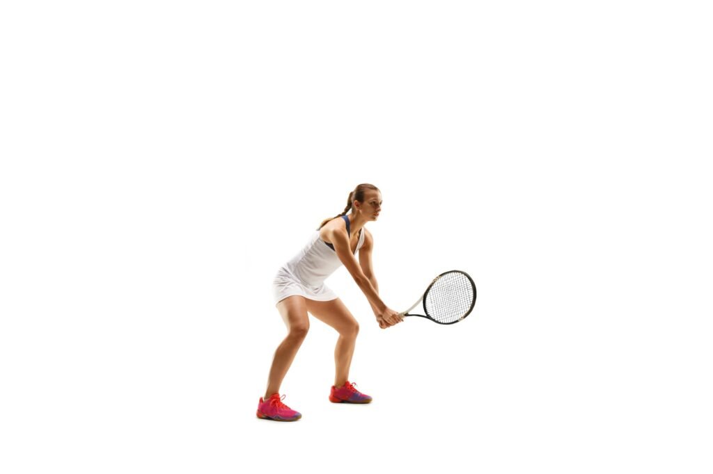 Adult woman playing tennis. Studio shot over white.