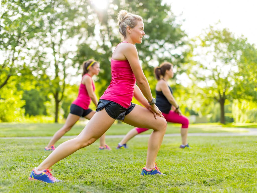 Jogging coach streching with clients